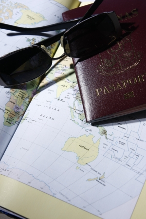 A photo of travel paraphernalias such as map, passport and sunglassesの写真素材