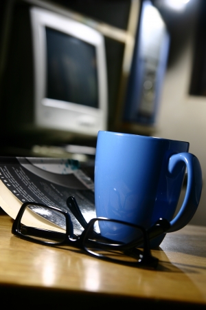 Coffee Break - Computer  A photo of a coffee mug, eyeglasses, book, and a computerの写真素材