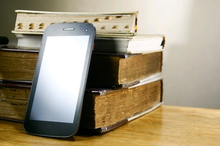 Smartphone or phablet or tablet and old booksの素材