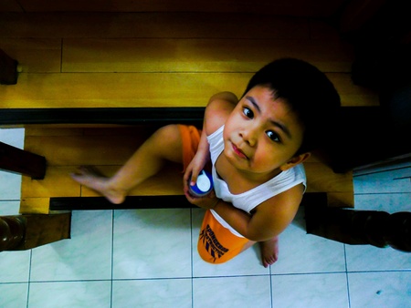 Asian child sitting on stairsの素材
