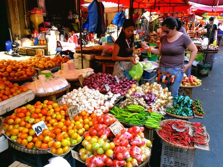 Asian street vendor selling vegetables and other food in quiapo, manila, philippines in asiaの素材