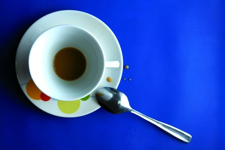 Finished coffee in a cup and saucer with teaspoonの素材