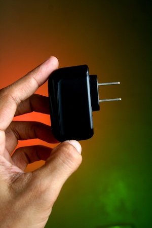 Hand holding a gadget chargerの素材