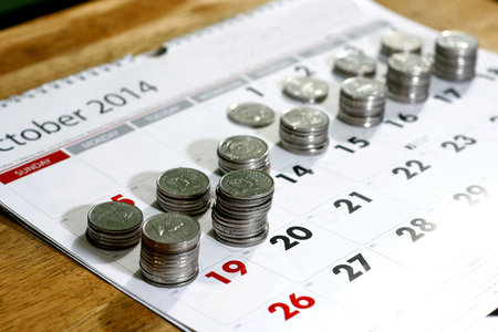 Stacks or piles of coins and a calendar