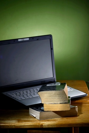 Stack or pile of books and a computer laptopの素材