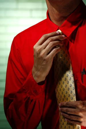 Man wearing red long sleeve shirt and yellow necktieの写真素材