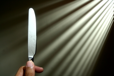 Hand holding a knifeの写真素材