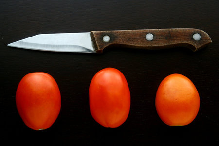 Knife and fresh ripe tomatoes