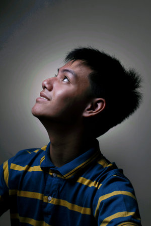 Male teenager looking upの写真素材