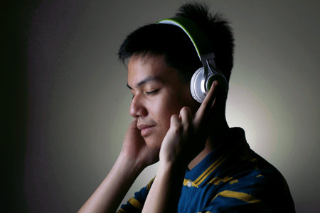 Male teenager with headphones or earphonesの写真素材