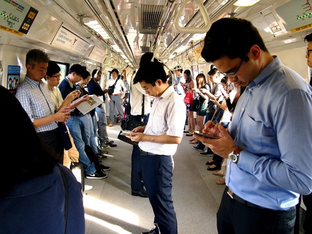 Passengers in a train use their cellphone or smartphoneの素材