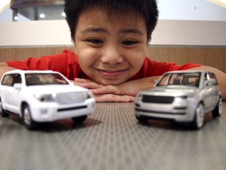 Young boy looking at toy carsの写真素材