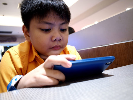 Young boy watching video on a smartphone