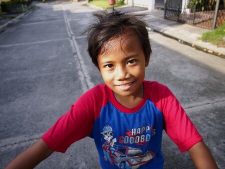 A young Filipino boy pose and smile for the cameraの素材