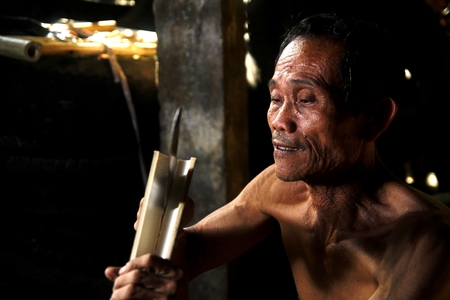 Bamboo furniture maker cutting bambooの写真素材