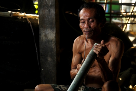 Bamboo furniture maker cutting bambooの写真素材