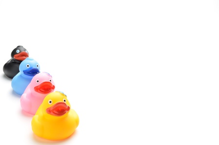 Many ducks toy of different colors on a over white backgroundの写真素材