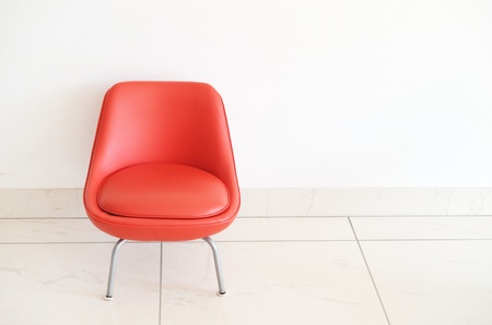 Red Chair to face a blank wallの写真素材