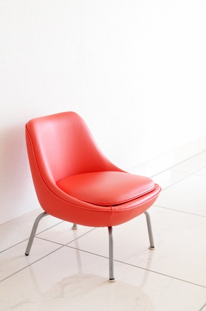 Red Chair to face a blank wallの写真素材