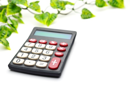 Calculator with leaf isolated on white backgroundの写真素材