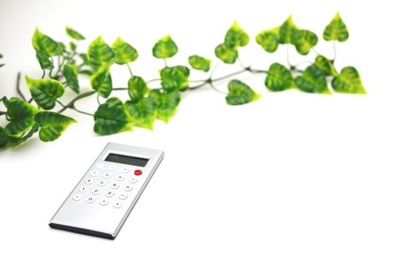 Calculator with leaf isolated on white backgroundの写真素材