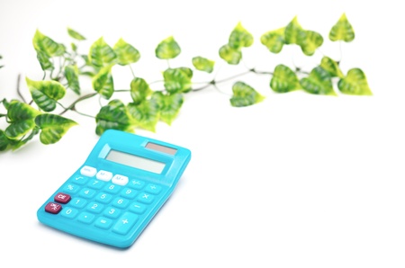 Calculator with leaf isolated on white backgroundの写真素材