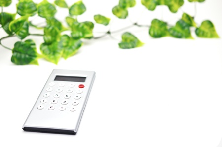 Calculator with leaf isolated on white backgroundの写真素材