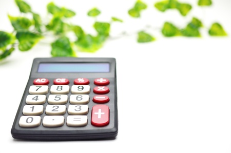 Calculator with leaf isolated on white backgroundの写真素材