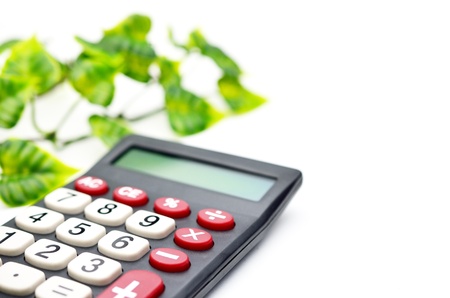 Calculator with leaf isolated on white backgroundの写真素材