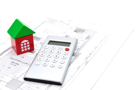 Model house and calculator on construction planの写真素材
