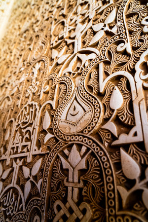 Exquisite Stucco Patterns of Alhambra Highlighting Floral Motifs and Arabic Calligraphy in a Stunning Geometric Designの写真素材