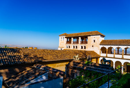 Alhambraâs Generalife Courtyard, Tranquil Gardens and Iconic Architecture Under a Vibrant Blue Andalusian Skyの写真素材