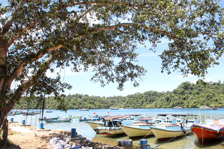Sendang biru beach in the southern part of Malang, east java indonesia with long tail boat, sail boat, and yachtのeditorial素材