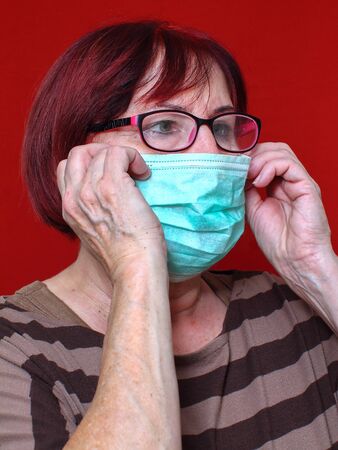 A woman is wearing a face mask because of the epidemicの写真素材