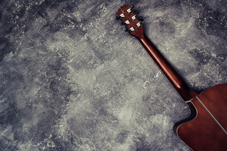 Acoustic guitar resting against a background with copy spaceの写真素材