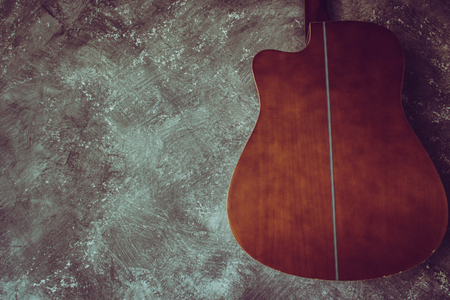 Acoustic guitar resting against a background with copy spaceの写真素材