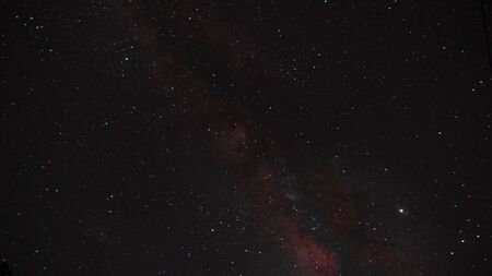 Time lapse of galaxies and meteor at nightの写真素材