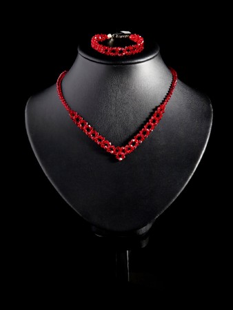 Necklace and bracelet on a black background.の写真素材
