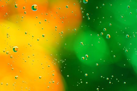 Drops of water on a green, yellow background.の写真素材