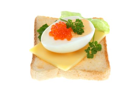 Toast with trout caviar, cheese, egg and vegetables.の写真素材