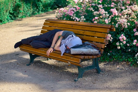 Opava, Czech republic, 21 June, 2015, Sleeping man which is take a rest on bench in the shade during hot day, Opava, Czech Republicの写真素材