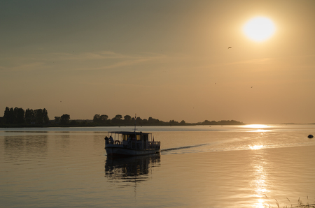 Visla river in Plock with boat in the sunset ray / Polandの写真素材