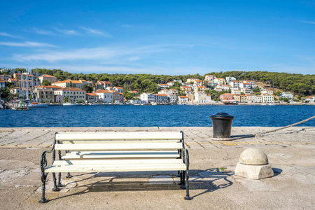 Panorama of Mali Losinj from the city coast with bench and anchorage, Croatia
