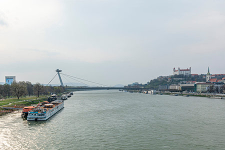 View of the sunset from the old bridge towards the SNP bridge and Bratislava Castle. Danube River. Slovakia.の写真素材