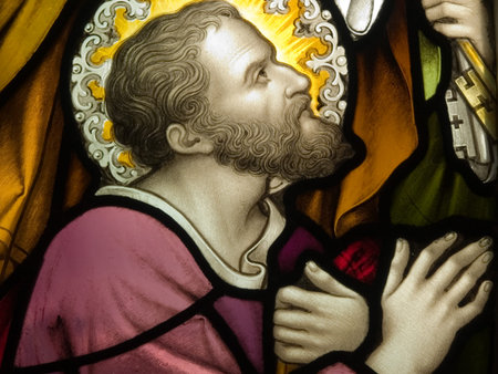 Stained glass in Catholic church in Dublin showing a saint in deep prayer