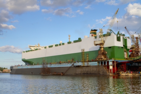 A hull of a ship is being renovated in a dry dockの写真素材