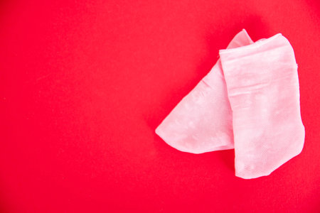 beautiful pink socks on red background. Close up. Art soft focus
