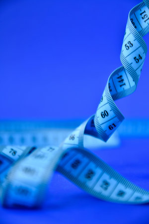 centimeter tape on a blue background. art soft focus