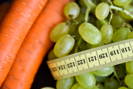 Carrots and grapes with centimeter tapeの写真素材