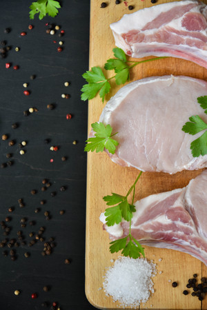 Raw steak on a wooden board.の写真素材
